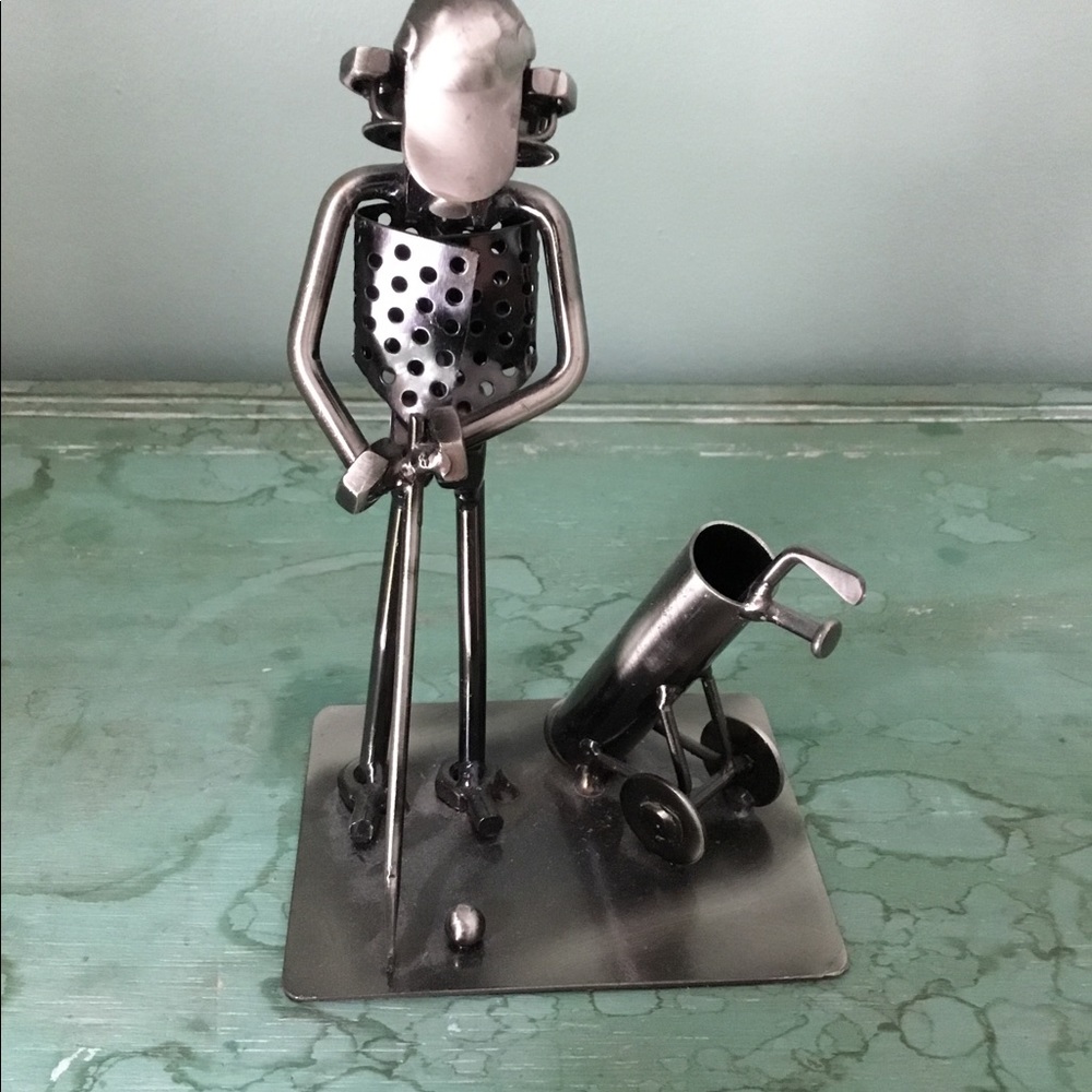 Metal golfer sculpture by Roland